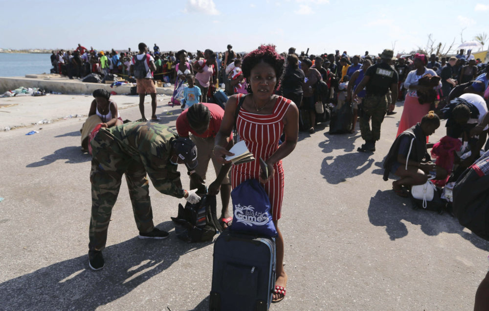 A Bahama's Army officer registers the people prior boarding a ferry to Nassau at the Port in Marsh Harbor, Abaco Island, Bahamas, Saturday, Sept. 7, 2019. The Bahamian health ministry said helicopters and boats are on the way to help people in affected areas, though officials warned of delays because of severe flooding and limited access. (Fernando Llano/AP)
