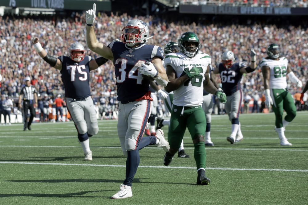 Rex Burkhead, runner for the New England Patriots, achieves a scoring run against the New York Jets on Sunday. (Steven Senne/AP)