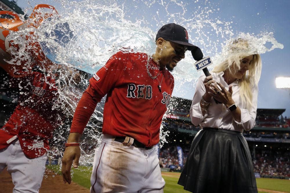 A teammate douses Boston Red Sox's Mookie Betts, center, after Betts scored a walkoff run during the ninth inning of a baseball game against the Baltimore Orioles in Boston, Sept. 29, 2019. (Michael Dwyer/AP)
