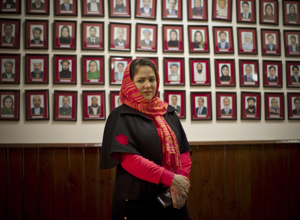 Afghan lawmaker Fawzia Koofi from Kabul poses next to a picture wall showing Afghanistans 249 parliamentarians. (Anja Niedringhaus/AP)