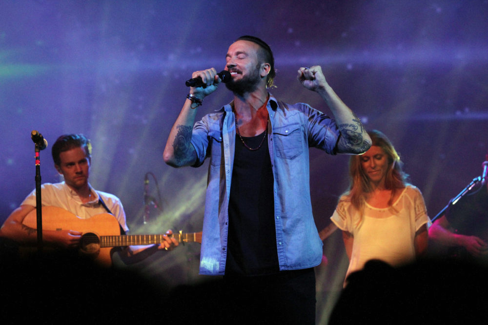 Pastor Carl Lentz, center, leads a Hillsong NYC Church service at Irving Plaza in New York.  (Tina Fineberg/AP)