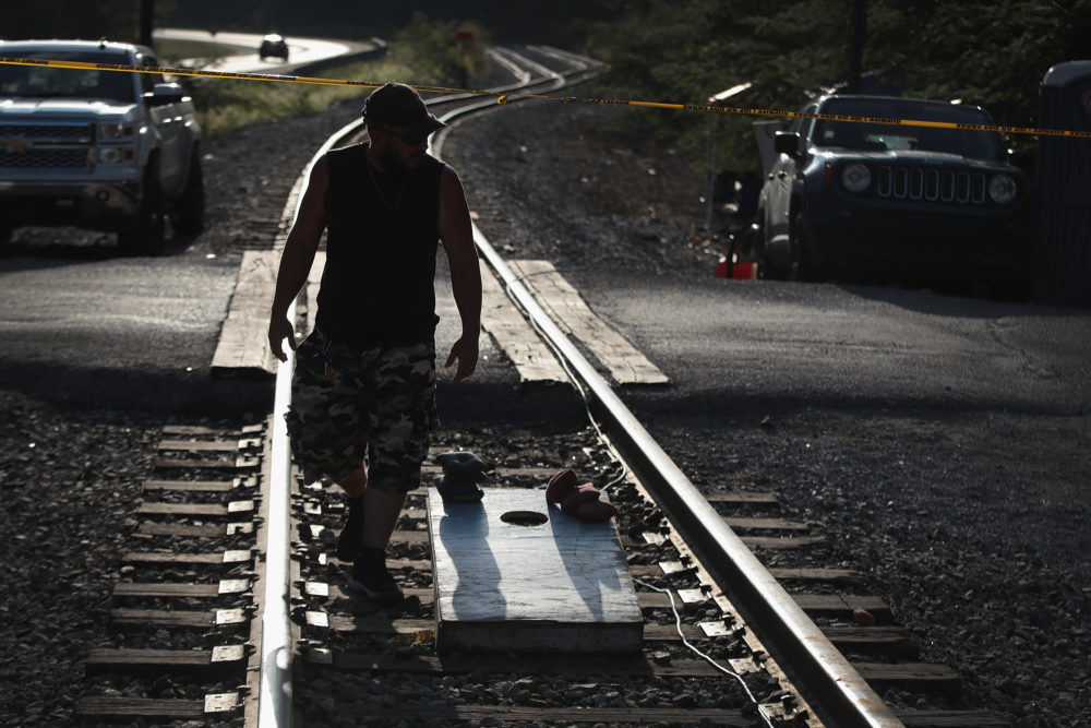 An unemployed Blackjewel coal miner, mans a blockade of the railroad tracks that lead to the mine where he once worked in Cumberland, Kentucky. (Scott Olson/Getty Images)