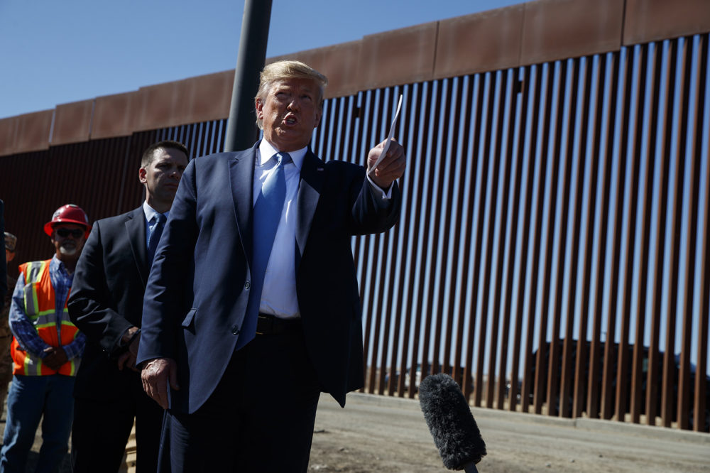 President Trump talks with reporters as he tours a section of the southern border wall on Sept. 18 in Otay Mesa, Calif. (Evan Vucci/AP)