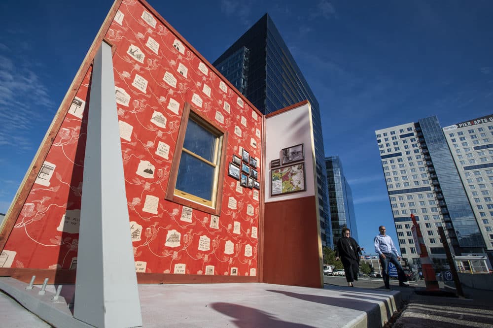 Pat Falco's latest public installation in the Seaport takes the form of a full-scale mock up and shifts it to a triple decker. (Jesse Costa/WBUR)
