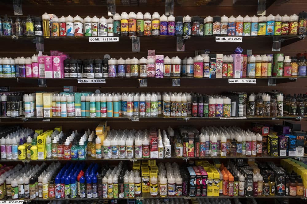 Shelves of vaping juices along a wall at Smoker Choice in Salem, NH. (Jesse Costa/WBUR)