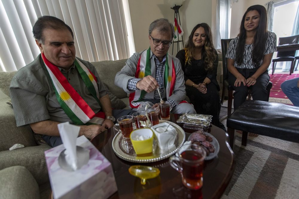 Omar Osman Omer, son Delshad Osman, and daughters Shawnam and Ala Osman, enjoy afternoon tea in their home in Dorchester. (Jesse Costa/WBUR)