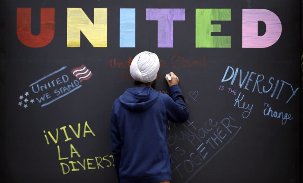 In this December 6, 2016 photo, Texas A&M student Harsimran Singh, from India, signs a message board at an event in College Station, Texas. (David J. Phillip/AP)