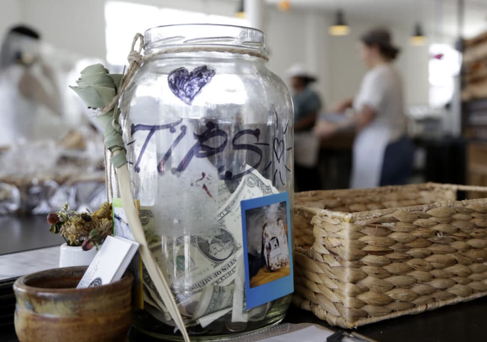 A tip jar sits on the counter at Zak the Baker in Miami. (Lynne Sladky/AP)