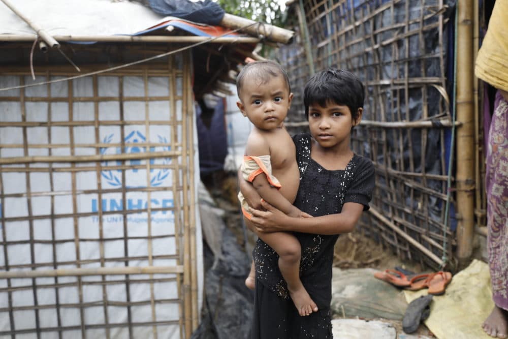 A Rohingya refugee girl holds a child  at the Kutupalong refugee camp in Cox's Bazar district, Bangladesh, Monday, June 2, 2018. (AP)