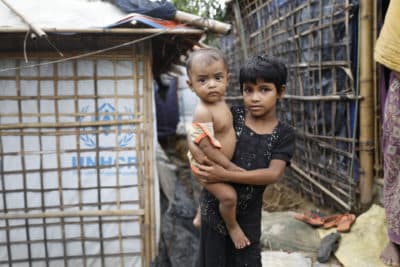 A Rohingya refugee girl holds a child  at the Kutupalong refugee camp in Cox's Bazar district, Bangladesh, Monday, June 2, 2018. (AP)