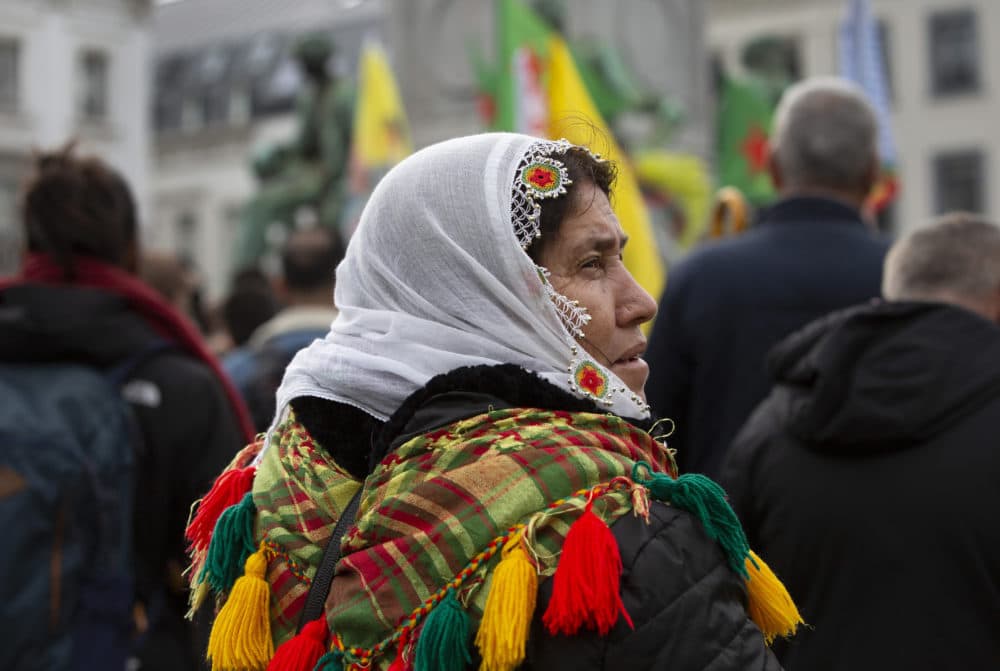 A Kurdish woman participates in a demonstration outside European Parliament in Brussels, Wednesday, Oct. 9, 2019. Turkey launched a military operation Wednesday against Kurdish fighters in northeastern Syria after U.S. forces pulled back from the area, with a series of airstrikes hitting a town on Syria's northern border. (Virginia Mayo/AP)