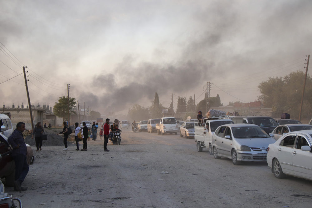 Syrians flee shelling by Turkish forces in Ras al Ayn, northeast Syria, Wednesday, Oct. 9, 2019. Turkish President Recep Tayyip Erdogan announced Wednesday the start of a Turkish military operation against Kurdish fighters in northeastern Syria. (AP Photo)