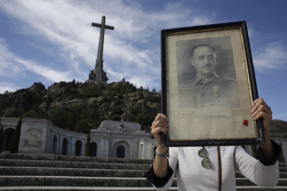 A visitor holds a portrait of Francisco Franco at the Valley of the Fallen mausoleum on the outskirts of Madrid. (Alfonso Ruiz/AP)
