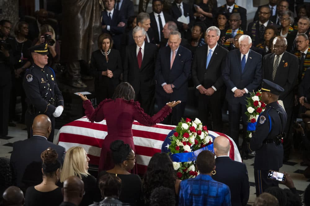 Maya Rockeymoore Cummings, widow of the late Rep. Elijah Cummings, D-Md., pauses at his casket in Statuary Hall as Congressional leaders look on, during his memorial service on Thursday, Oct. 24, 2019. (Tom Williams/Pool via AP)