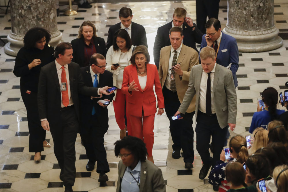 House Speaker Nancy Pelosi of Calif., center, is followed by members of media as she leaves the House Chamber after announcing that the House votes 232-196 to pass resolution on impeachment procedure to move forward into the next phase of the impeachment inquiry into President Trump on Capitol Hill in Washington, Thursday, Oct. 31, 2019. The resolution would authorize the next stage of impeachment inquiry into President Donald Trump, including establishing the format for open hearings, giving the House Committee on the Judiciary the final recommendation on impeachment, and allowing President Trump and his lawyers to attend events and question witnesses. (AP Photo/Pablo Martinez Monsivais)