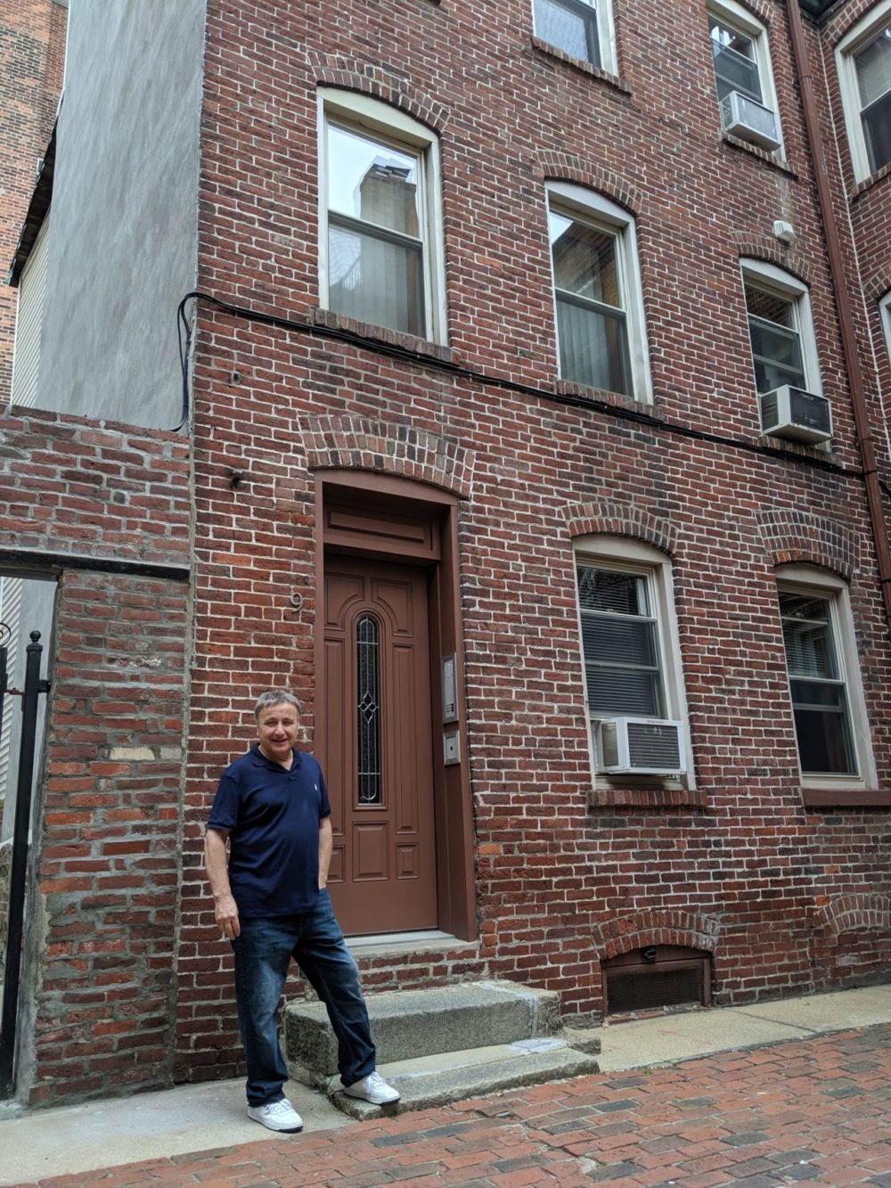 Anthony Martignetti stands on Powers Court in the North End in 2019. (Jamie Bologna/WBUR)
