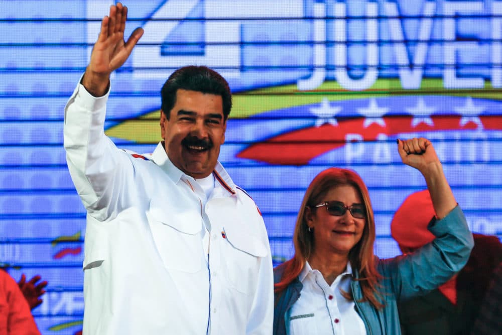 Nicolas Maduro and his wife Cilia Flores wave during celebrations in the framework of the &quot;Youth Day&quot; at the Bolivar Square in Caracas, Venezuela, on Feb. 12, 2019. (Orangel Hernandez/AFP/Getty Images)