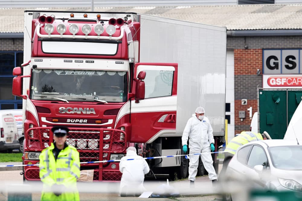 Police and forensic officers investigate a lorry in which 39 bodies were discovered in the trailer, as they prepare move the vehicle from the site on October 23, 2019, in Thurrock, England. (Leon Neal/Getty Images)