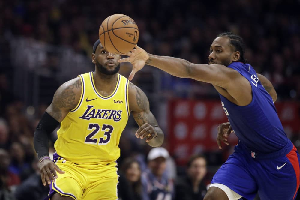 Kawhi Leonard (right) steals the ball from LeBron James during Tuesday's Clippers/Lakers game. (Marcio Jose Sanchez/AP)