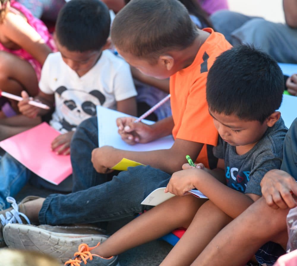 Asylum-seeking children draw during Sunday classes led by Team Brownsville. (Courtesy Paul Goyette)