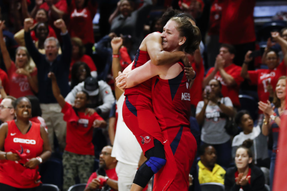 Washington Mystics guard Kristi Toliver, left, jumps into the arms of Emma Meesseman at the end of Game 5 of the WNBA Finals. (Alex Brandon/AP)