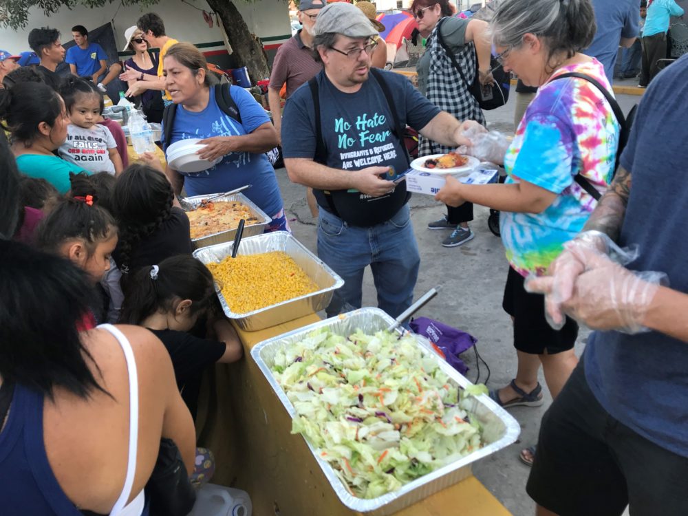Team Brownsville volunteers serving dinner to asylum seekers stuck in Matamoros, Mexico (Andrea Asuaje/WBUR)