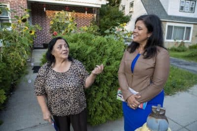 While canvasing through a Roslindale neighborhood in September 2019, Alejandra St. Guillen, left, listens to resident Radrigunda Marmanillo, speak about some of the issues in the area. (Jesse Costa/WBUR)