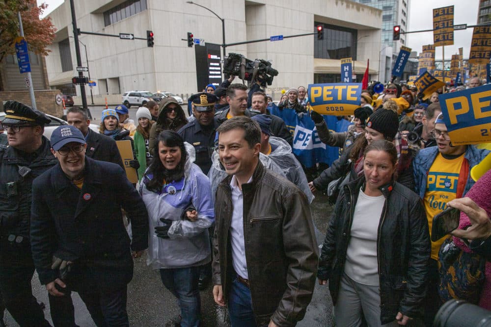 South Bend, Indiana Mayor Pete Buttigieg marches down a street in Des Moines, Iowa, with supporters before the Liberty and Justice Celebration on November 1, 2019. (Clay Masters/Iowa Public Radio)