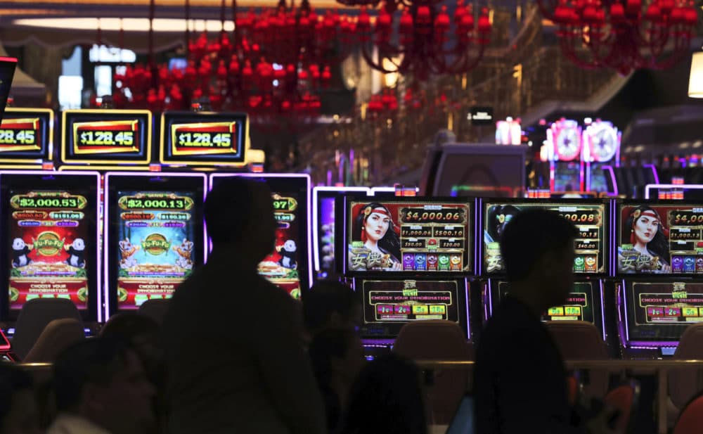 Casino workers near the gaming floor at the Encore Boston Harbor casino in Everett. (AP Photo/Charles Krupa)
