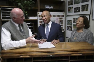 Democratic presidential candidate former Massachusetts Gov. Deval Patrick speaks to New Hampshire Secretary of State Bill Gardner, left, as he files to have his name listed on the New Hampshire primary ballot, Thursday, Nov. 14, 2019, in Concord, N.H. At right is his wife Diane Patrick. (Charles Krupa/AP)