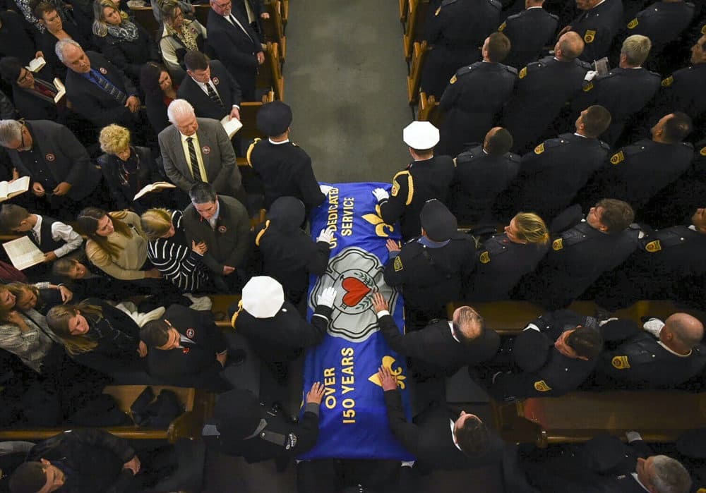 Pall bearers carry the casket of Worcester firefighter Lt. Jason Menard into his funeral mass in St. John's Church in Worcester, Mass. Monday Nov. 18, 2019. Mourners from fire departments across the region are expected at the funeral of the fire lieutenant who died after saving two colleagues. (Ashley Green/The Telegram &amp; Gazette via AP, Pool)
