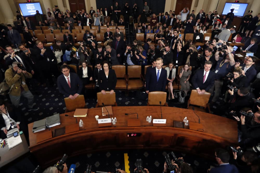 Former White House national security aide Fiona Hill, second from left, and David Holmes, a U.S. diplomat in Ukraine, stand behind their chairs as they arrive to testify before the House Intelligence Committee Thursday during a public impeachment hearing. (Andrew Harnik/AP)