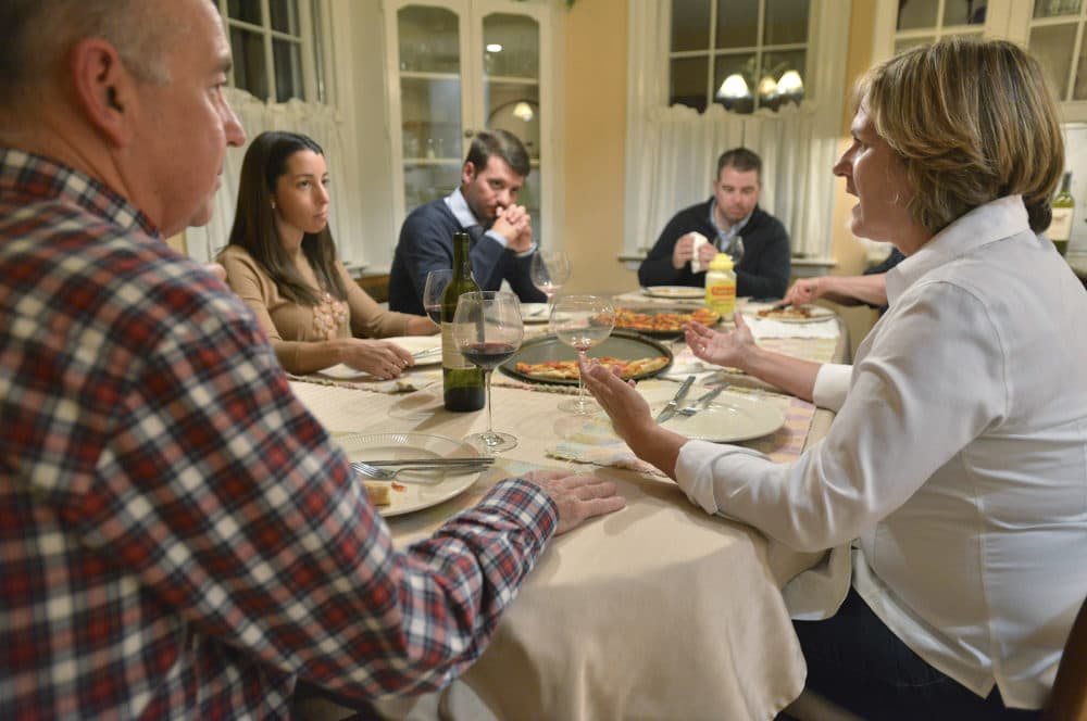 Anne Brennan, right, of Hingham Mass., speaks as, from left, brother-in-law Steve Marshall, of Hingham, niece Rebecca Malone, and her husband Brian Malone, both of Duxbury, Mass., and nephew Andrew Marshall, of Quincy, Mass., are gathered for dinner in Hingham, Mass., where politics are a frequent, and divisive topic of conversation. (Josh Reynolds/AP)