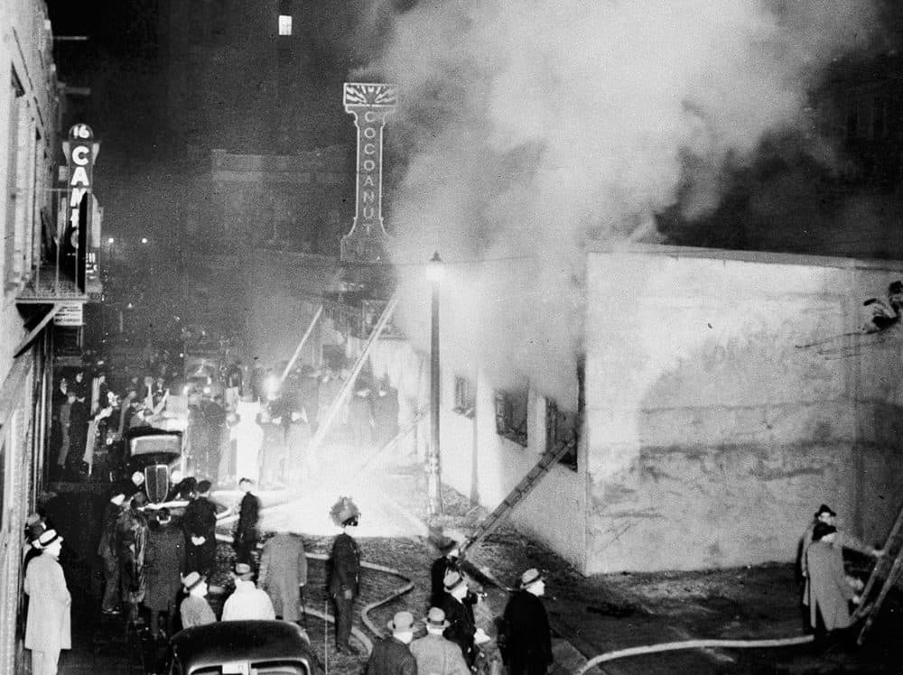 In this Nov. 28, 1942 photo, smoke pours from the Cocoanut Grove nightclub, right, during a fire in Boston's Back Bay, where 492 people died and hundreds more were injured. The fire still stands today as the nation’s deadliest nightclub fire and led to stricter enforcement of fire codes and to innovations in the treatment of burn victims. (AP Photo)