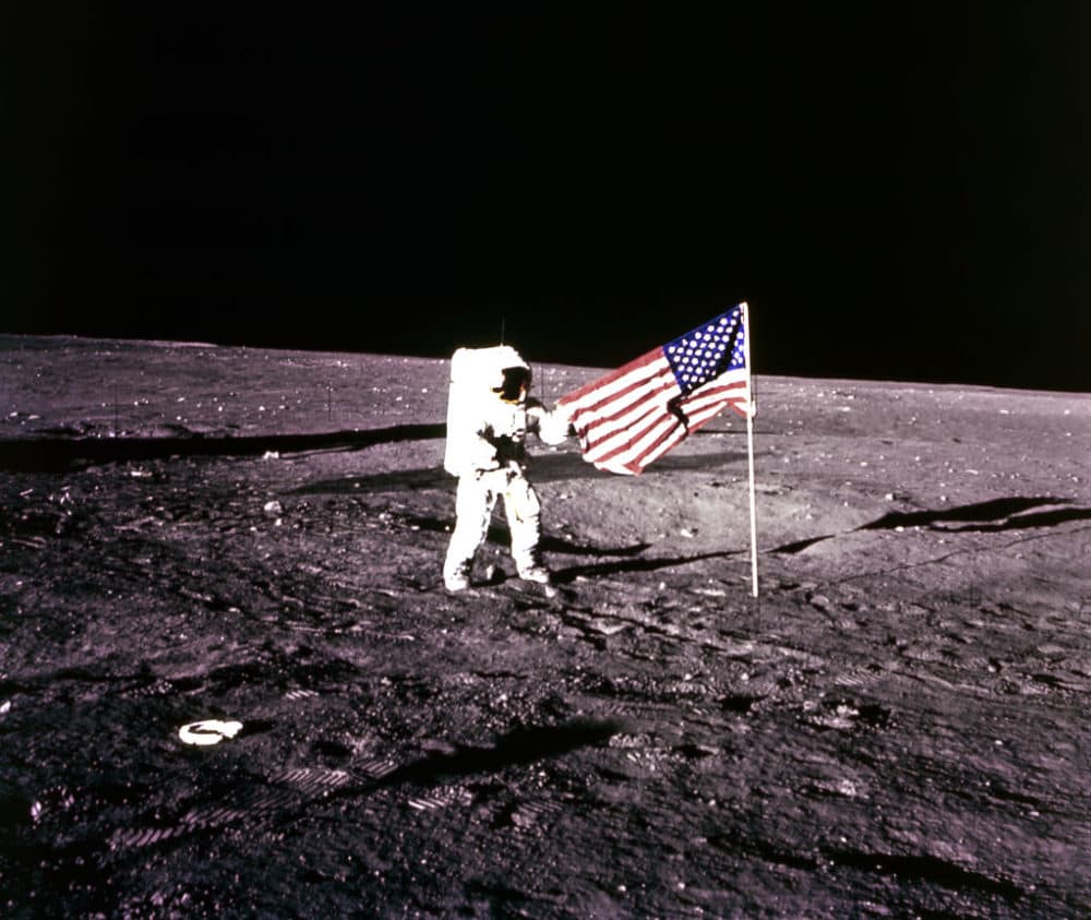 This 19 November 1969 file photo released by NASA shows Apollo 12 Astronaut Charles &quot;Pete&quot; Conrad standing by the US flag on the Moon. (AFP via Getty Images)