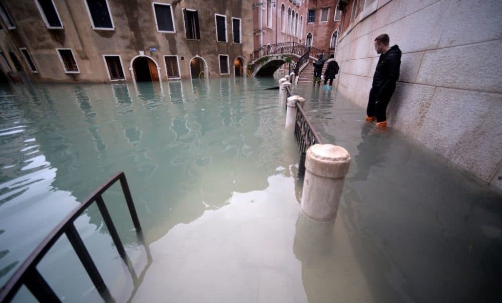 People stand in flooded Venice streets. (Filippo Monteforte/AFP/Getty Images)
