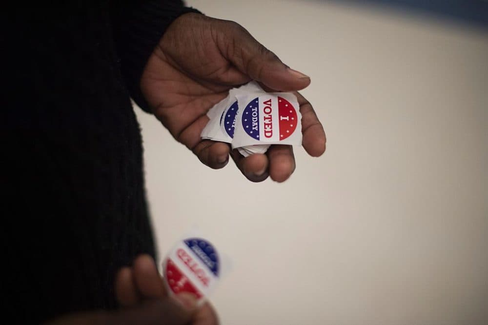 A polling manger holds &quot;I Voted&quot; stickers as she wait for people to cast their ballots in South Carolina. (Jim Watson/AFP/Getty Images)