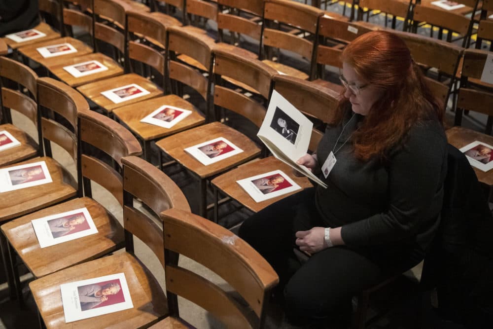 A woman looks through the program before the start of the Celebration of the Life of Toni Morrison on Nov. 21, 2019 at the Cathedral of St. John the Divine in New York. (Mary Altaffer/AP)