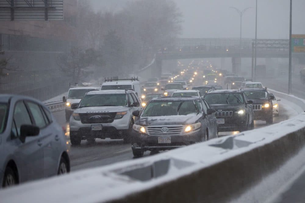 Commuters on Route 93 southbound move slowly as they leave Boston during a snowstorm. (Jesse Costa/WBUR)