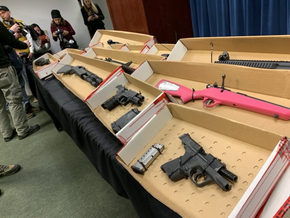 Federal authorities displayed the weapons seized as part of an early-morning sting against dozens of alleged gang leaders, members and associates. (Steve Brown/WBUR)