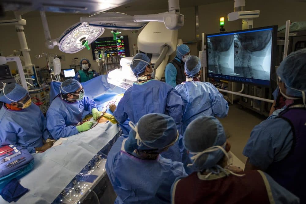 Vascular surgeon Doug Jones and his team perform a surgery to unblock the patient's carotid artery at Boston Medical Center. (Jesse Costa/WBUR)