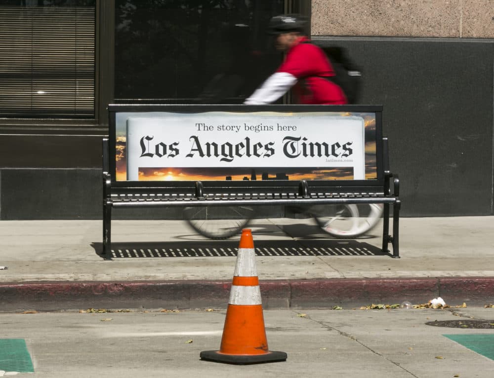 Recently, dozens of major metro newspapers — from the Los Angeles Times to the Miami Herald — have gotten into the audio newscast business. (Damian Dovarganes/AP)