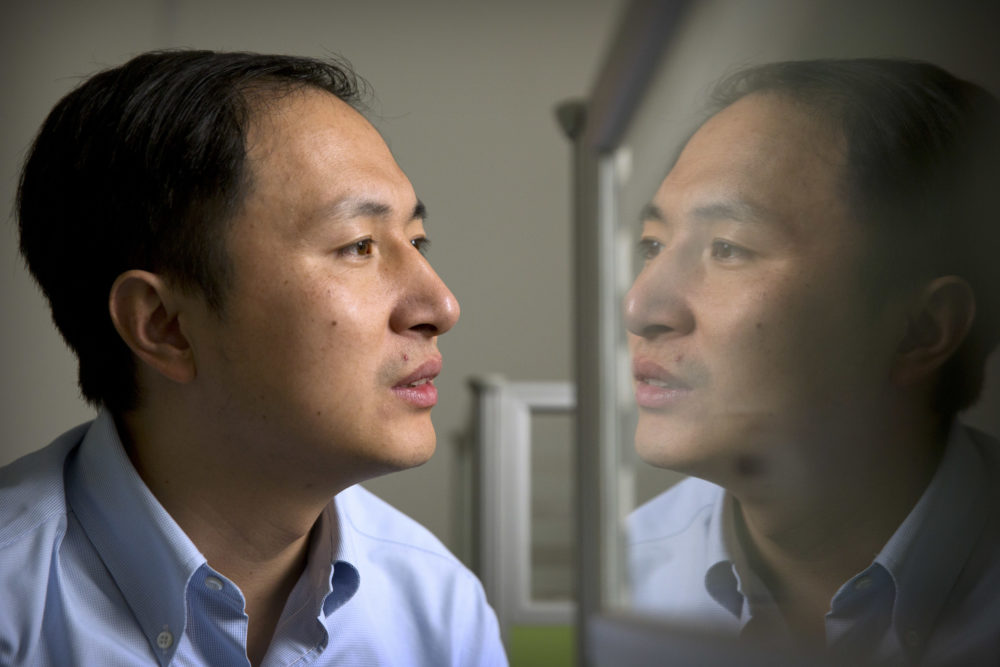 In this Oct. 10, 2018 photo, He Jiankui is reflected in a glass panel as he works at a computer at a laboratory in Shenzhen in southern China's Guangdong province. Chinese scientist He claims he helped make world's first genetically edited babies: twin girls whose DNA he said he altered. (Mark Schiefelbein/AP)