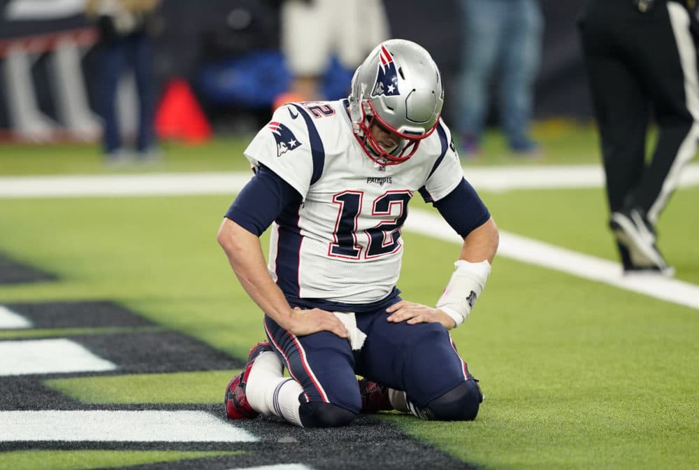 New England Patriots quarterback Tom Brady (12) kneels on the turn after a play during the second half of the game Sunday in Houston. (David J. Phillip/AP)