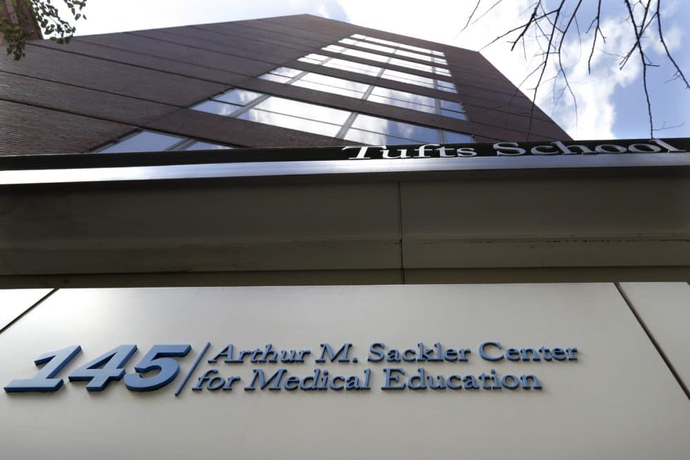 A sign at an entrance to Tufts School of Medicine, in Boston, identifies the address as the Arthur M. Sackler Center for Medical Education. Tufts announced Thursday, Dec. 5, it will strip the Sackler name from all of its institutions. (Steven Senne/AP/File)