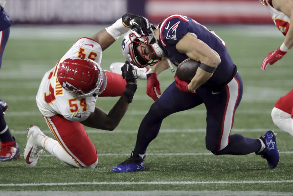 Kansas City Chiefs linebacker Damien Wilson, left, tackles New England Patriots wide receiver Julian Edelman in the second half of the game Sunday in Foxborough. (Charles Krupa/AP)
