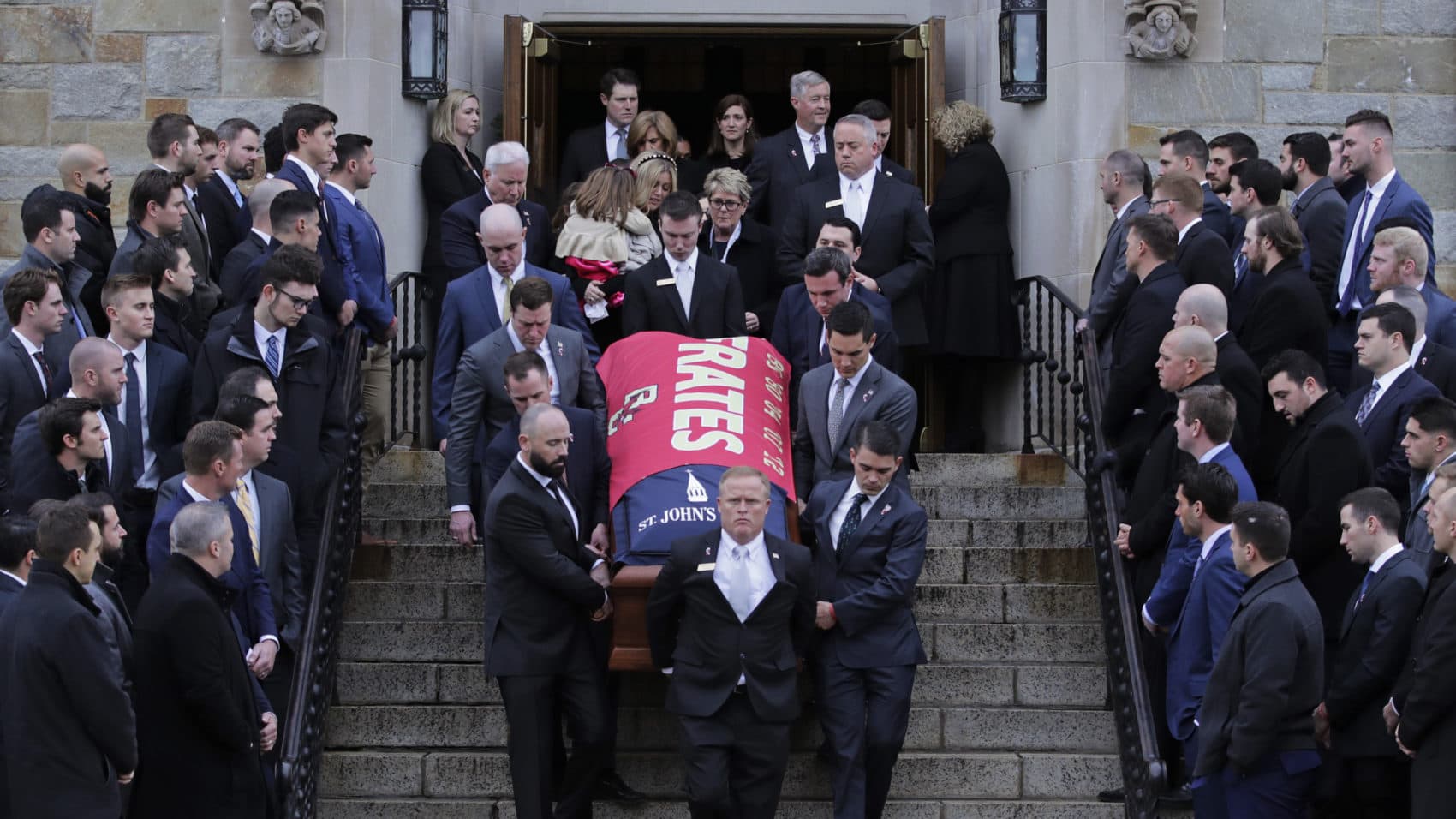 Boston College athletes, from past and present teams, watch as the casket is carried from the funeral of Pete Frates at St. Ignatius of Loyola Parish in Chestnut Hill. (Charles Krupa/AP)