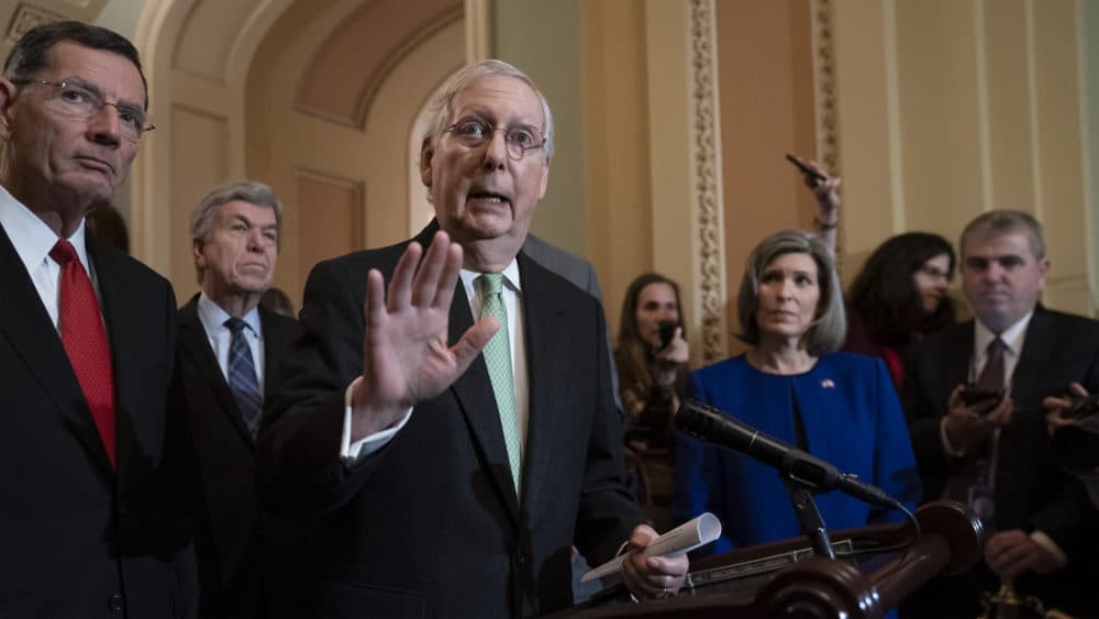 Senate Majority Leader Mitch McConnell, R-Ky., joined from left by Sen. John Barrasso, R-Wyo., Sen. Roy Blunt, R-Mo., and Sen. Joni Ernst, R-Iowa, dismisses the impeachment process against President Donald Trump saying, &quot;I'm not an impartial juror. This is a political process,&quot; as he meets with reporters at the Capitol in Washington, Tuesday, Dec. 17, 2019. (J. Scott Applewhite/AP)