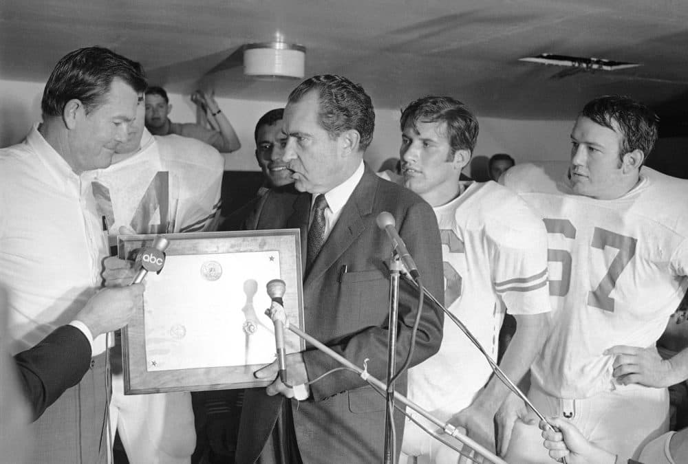 President Richard Nixon presents a plaque to Texas football coach Darrell Royal, naming the Longhorns the No. 1 college football team in college football's 100th year, Dec. 6, 1969. At right is Texas quarterback James Street. (AP Photo)