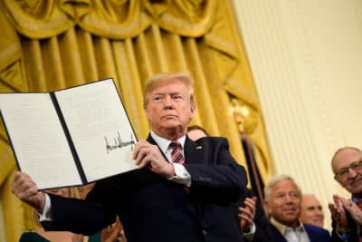 President Trump shows an executive order regarding anti-Semitism during a Hanukkah reception in the East Room of the White House, Dec. 11, 2019. (Brendan Smialowski/AFP via Getty Images)